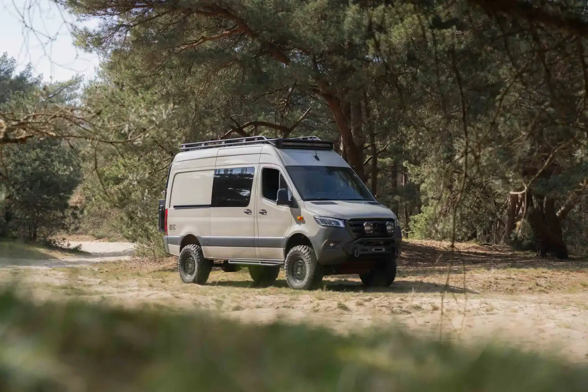 Mercedes Sprinter AWD in the forrest with a Dutchvanparts Camp 2 roof rack
